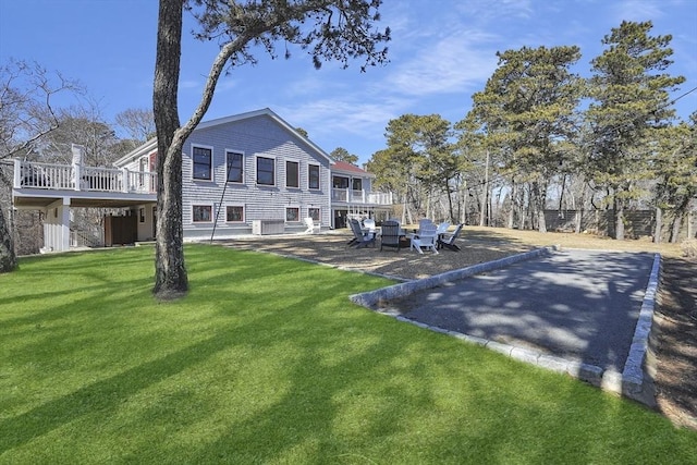 rear view of house with a yard, central AC, a patio area, and a wooden deck