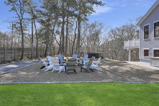 view of patio / terrace featuring an outdoor fire pit, fence, and a balcony