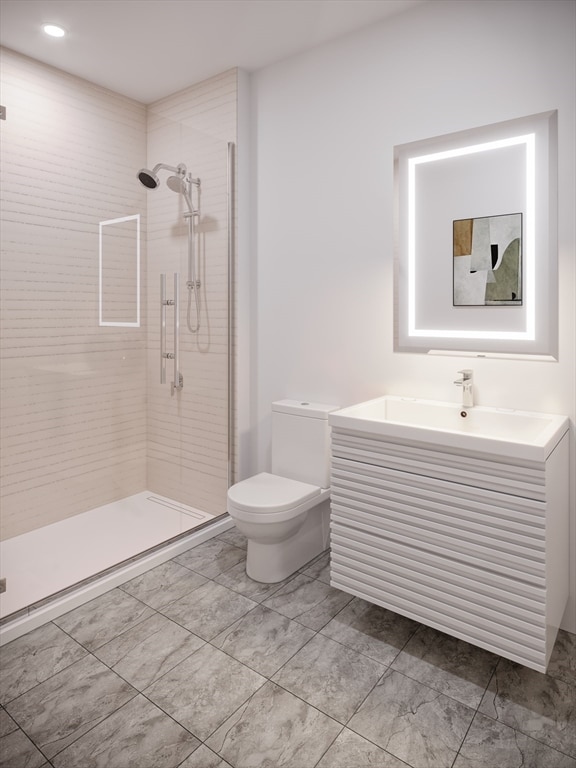 bathroom with vanity, toilet, and an enclosed shower