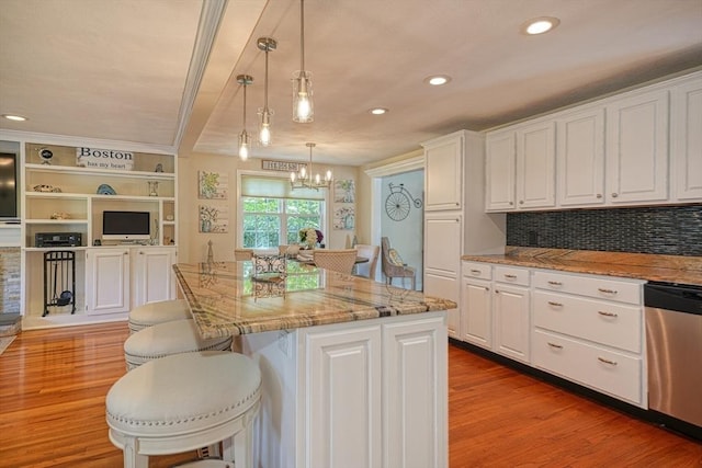 kitchen featuring white cabinetry, a center island, and dishwasher