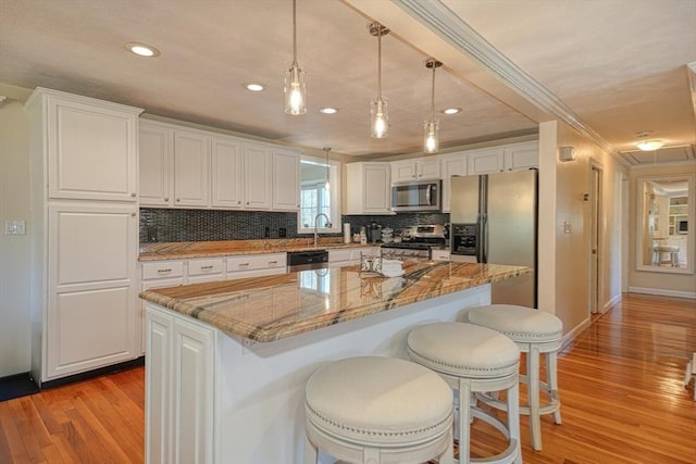 kitchen featuring decorative backsplash, light wood-style floors, recessed lighting, white cabinets, and appliances with stainless steel finishes