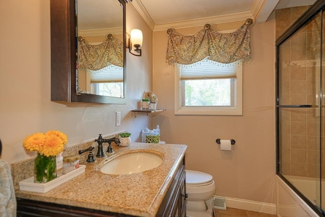 bathroom with vanity, ornamental molding, toilet, tile patterned floors, and enclosed tub / shower combo