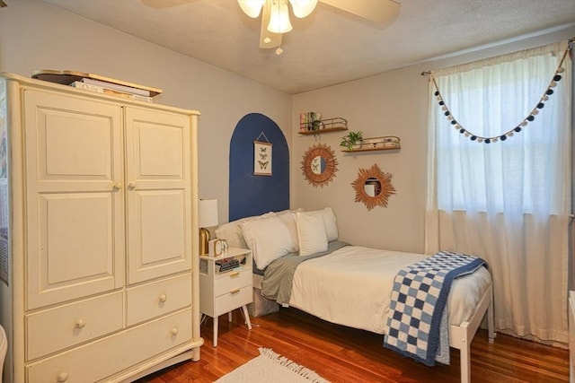 bedroom featuring ceiling fan and dark wood finished floors