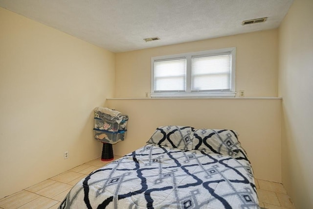 tiled bedroom featuring visible vents