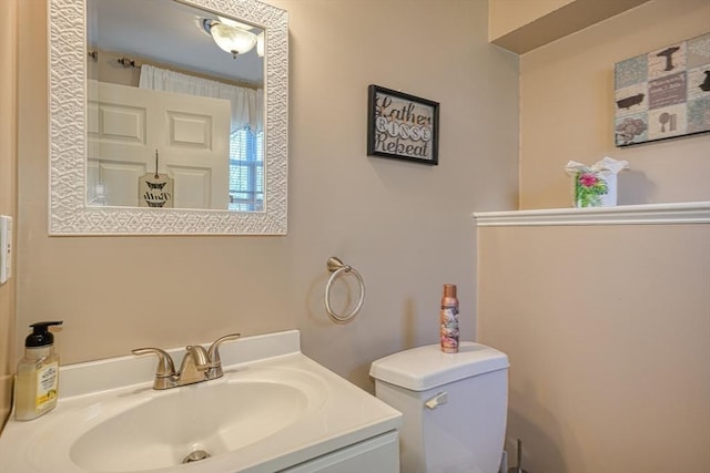 bathroom featuring vanity and toilet
