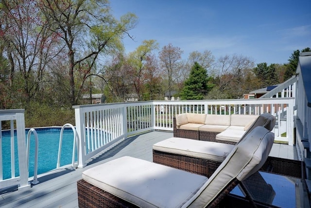 wooden terrace with an outdoor living space and an outdoor pool