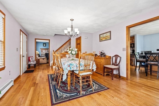 24 Floyd Ave, Tewksbury, MA 01876 - dining area with a baseboard radiator, a chandelier, light wood-type flooring, and baseboards