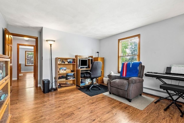 24 Floyd Ave, Tewksbury, MA 01876 - home office with wood finished floors, baseboards, and a baseboard radiator