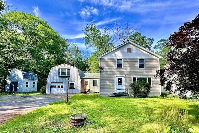 7 Lake Shore Dr, Georgetown, MA 01833 - view of front of home with a garage, asphalt driveway, an outdoor structure, a front yard, and entry steps