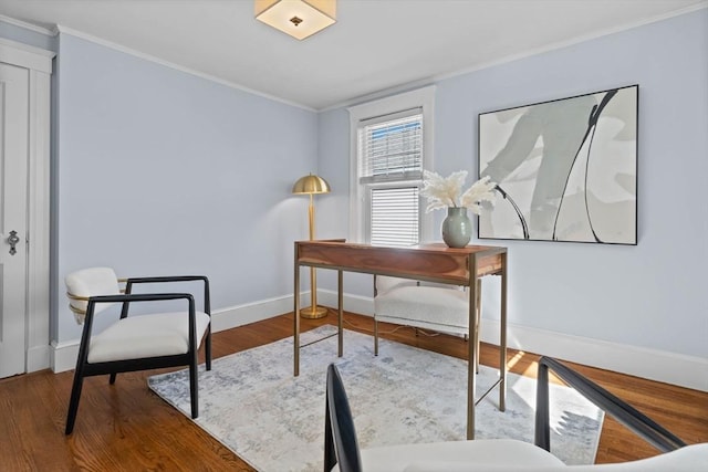 office area with crown molding, baseboards, and wood finished floors