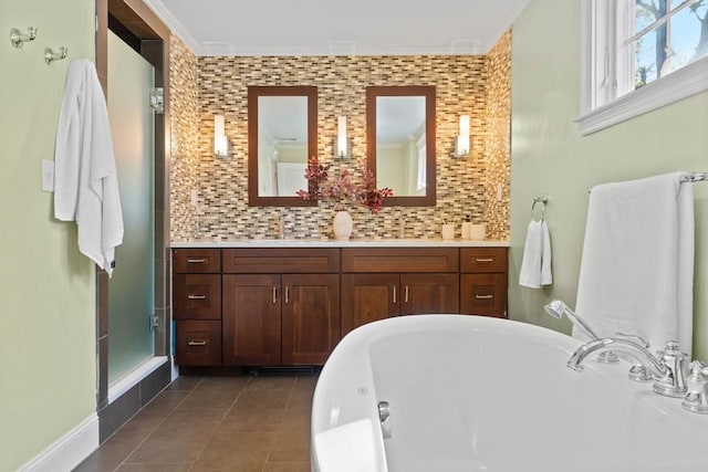 bathroom with vanity, a tub, tile patterned flooring, and tasteful backsplash