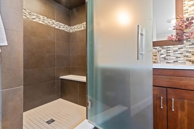 bathroom with vanity, decorative backsplash, and a shower stall