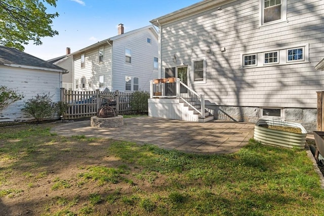 back of property with stairway, fence, a patio area, and an outdoor fire pit