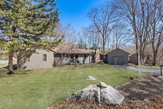 view of yard with an attached garage and driveway