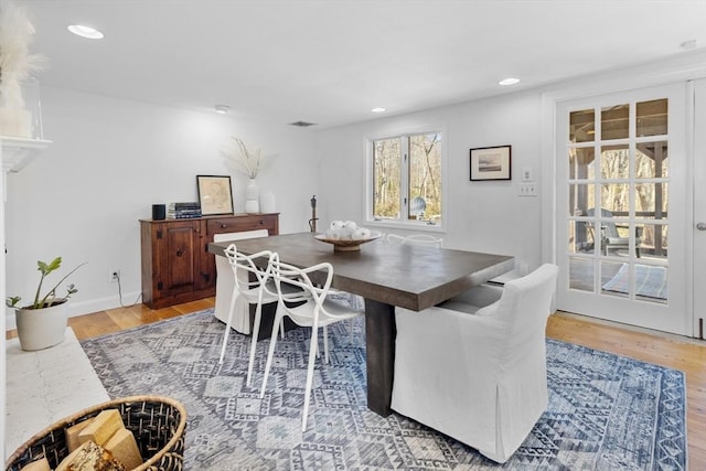 dining room with light wood finished floors and recessed lighting