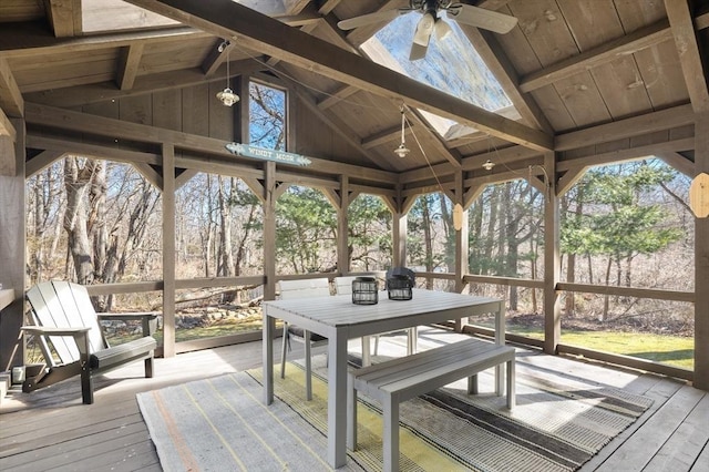 sunroom with plenty of natural light, ceiling fan, and vaulted ceiling