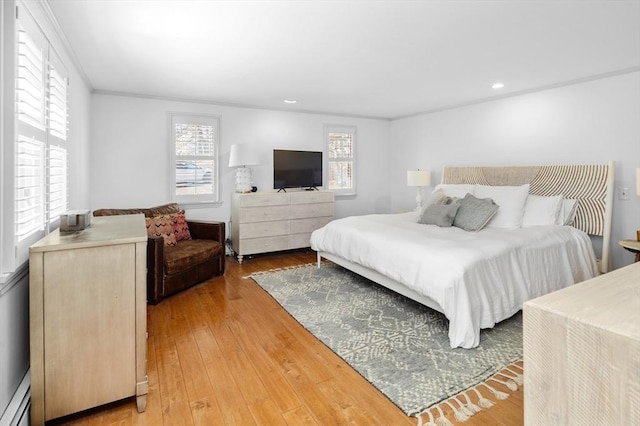 bedroom with baseboard heating, recessed lighting, light wood finished floors, and ornamental molding