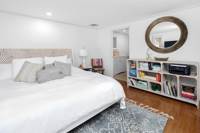 bedroom featuring recessed lighting, visible vents, wood-type flooring, and connected bathroom