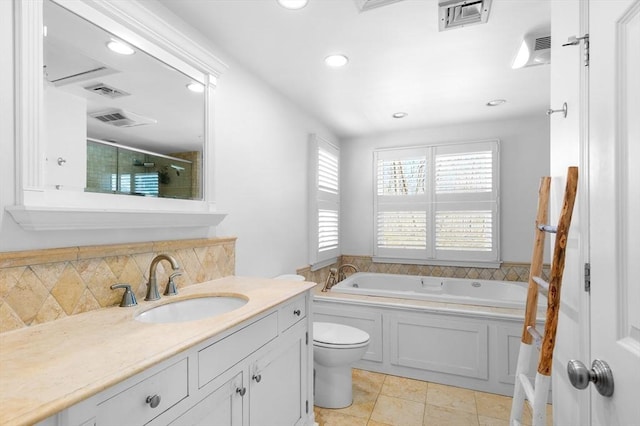 bathroom featuring tile patterned flooring, a bath, and visible vents