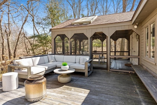 wooden terrace with a sunroom and an outdoor hangout area