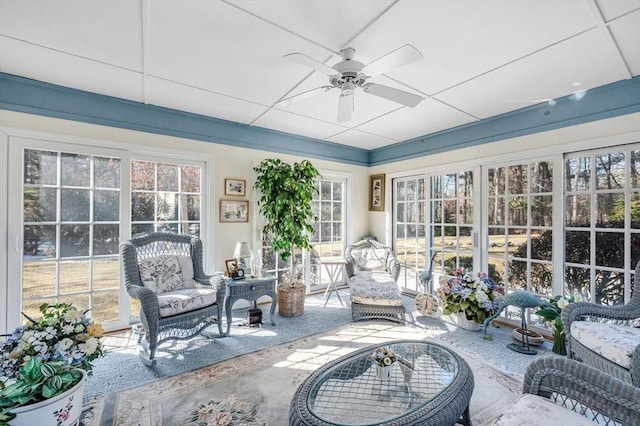 sunroom / solarium featuring a drop ceiling and ceiling fan