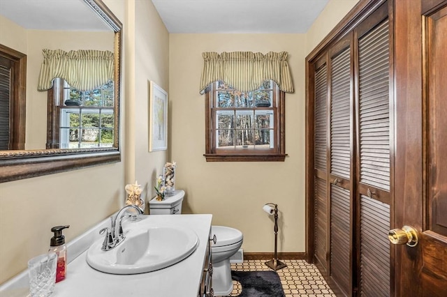 bathroom featuring vanity, toilet, and tile patterned flooring