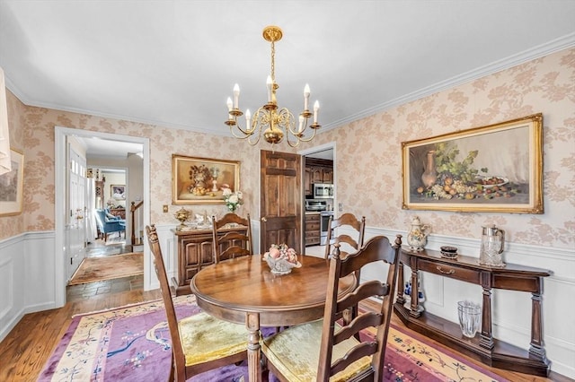 dining space with hardwood / wood-style floors and a chandelier