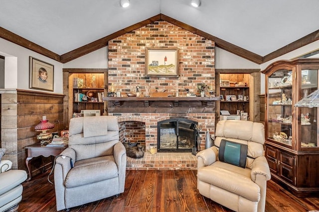 living room with dark wood-type flooring, vaulted ceiling, and a brick fireplace