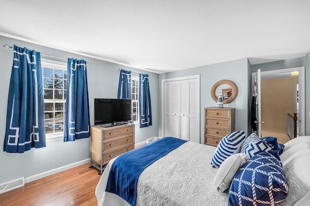 bedroom with hardwood / wood-style floors and a closet