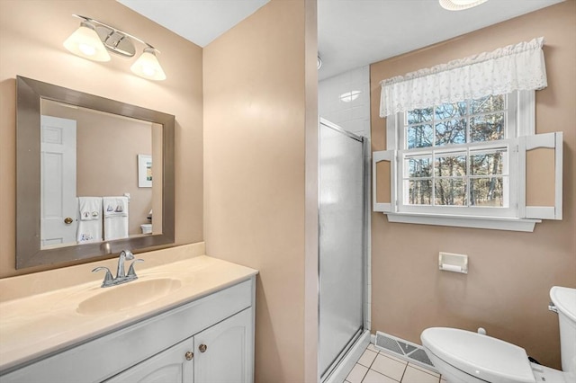 bathroom featuring toilet, vanity, tile patterned floors, and walk in shower