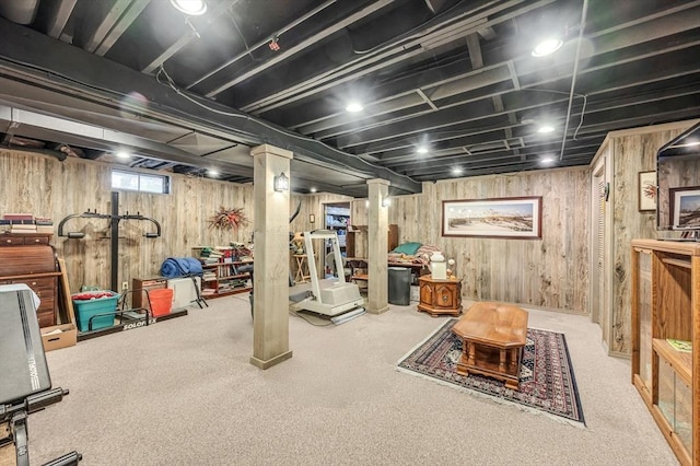 basement featuring carpet floors and wooden walls