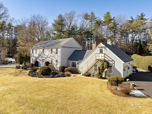 view of home's exterior with a garage and a lawn