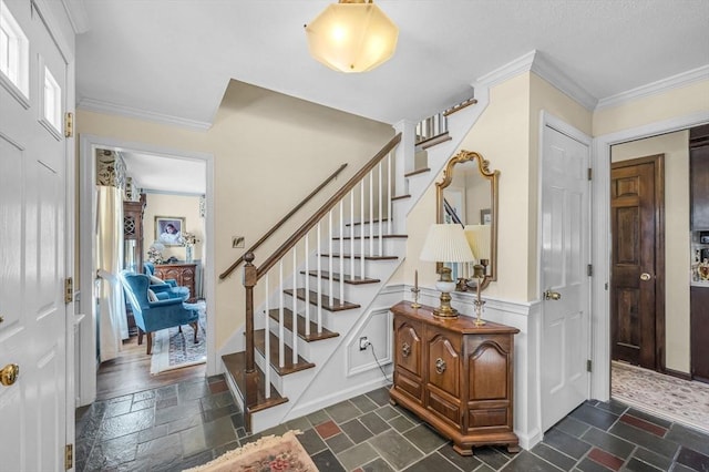 foyer featuring ornamental molding