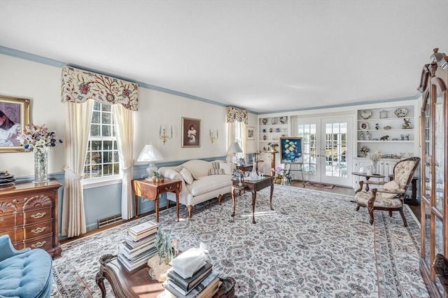 living room featuring french doors, hardwood / wood-style flooring, built in shelves, and a wealth of natural light