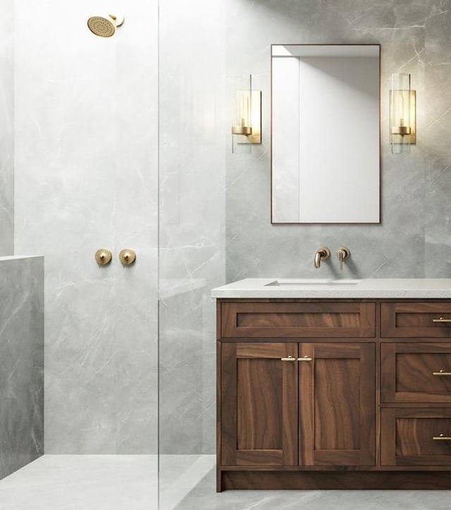 bathroom featuring tile walls, a tile shower, and vanity