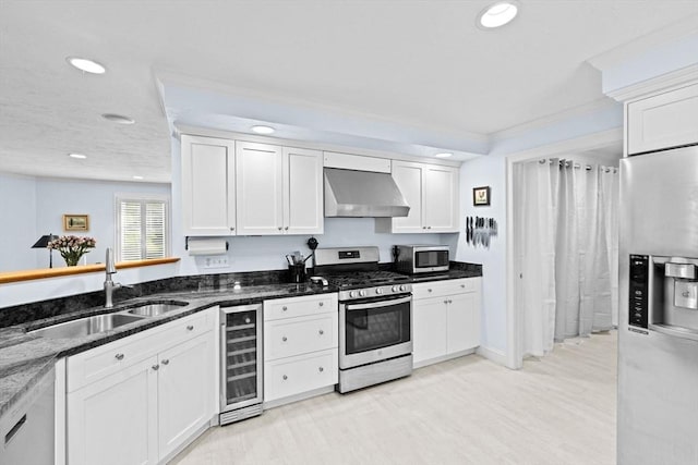 70 Humphreys Ln Unit 70, Duxbury, MA 02332 - kitchen with appliances with stainless steel finishes, wine cooler, exhaust hood, a sink, and recessed lighting