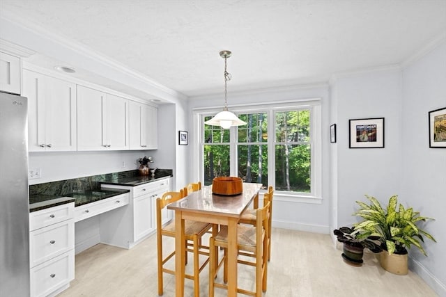 70 Humphreys Ln Unit 70, Duxbury, MA 02332 - kitchen featuring freestanding refrigerator, light wood-style floors, white cabinets, ornamental molding, and baseboards