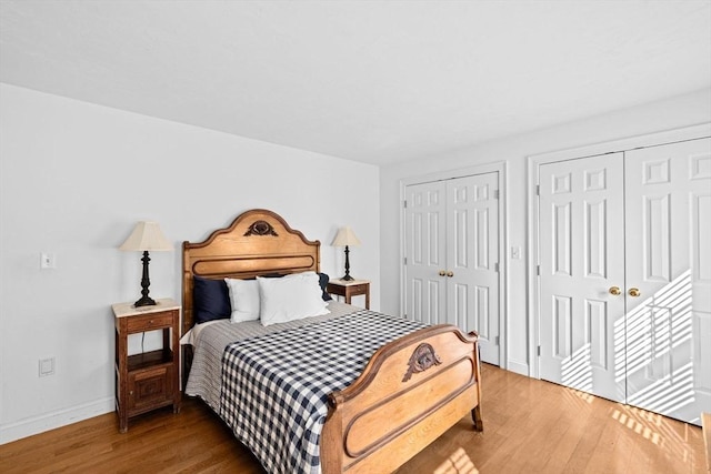 70 Humphreys Ln Unit 70, Duxbury, MA 02332 - bedroom featuring two closets, wood finished floors, and baseboards