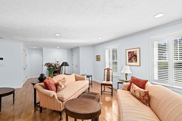 70 Humphreys Ln Unit 70, Duxbury, MA 02332 - living area featuring recessed lighting, light wood-style flooring, baseboards, a textured ceiling, and crown molding