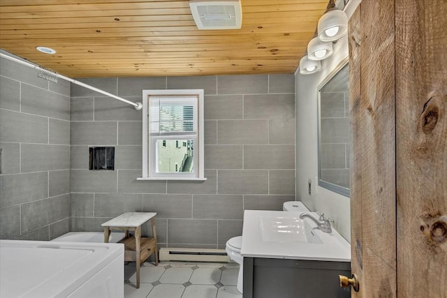 bathroom with wooden ceiling, a baseboard radiator, washer / clothes dryer, toilet, and tile walls