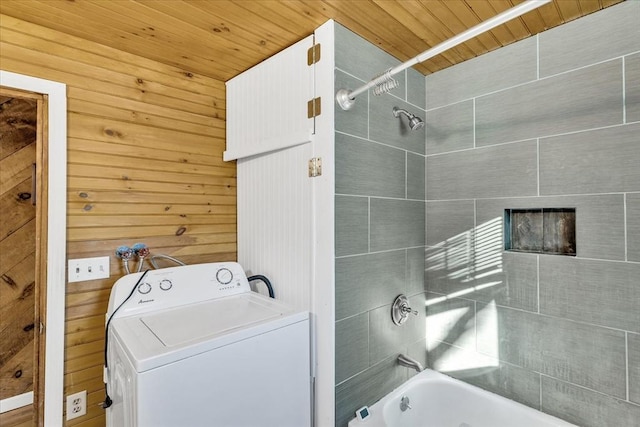 bathroom with washer / clothes dryer, wood walls, wooden ceiling, and tiled shower / bath