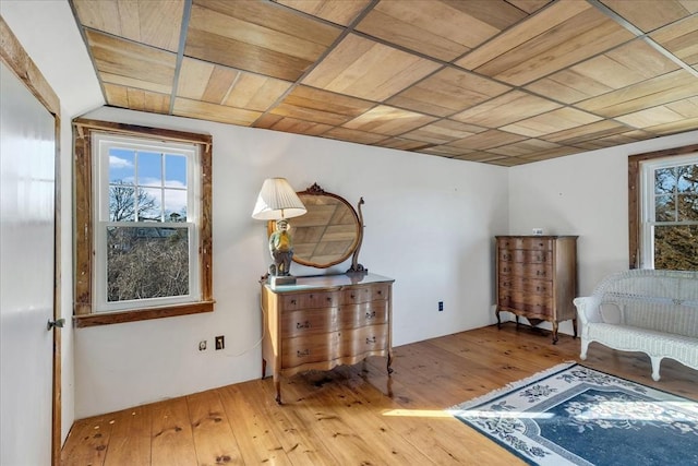 living area with hardwood / wood-style flooring and wooden ceiling