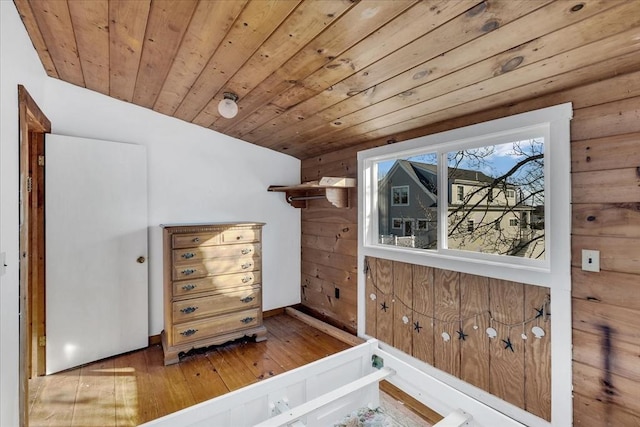 bonus room featuring wooden walls, wood ceiling, and wood-type flooring