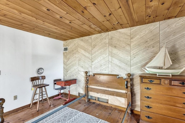 bedroom featuring hardwood / wood-style floors and wood ceiling