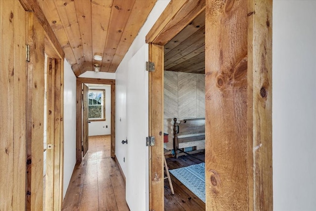 hall with wood-type flooring and wooden ceiling