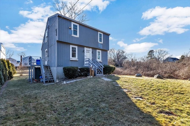 view of front of home featuring a deck and a front lawn