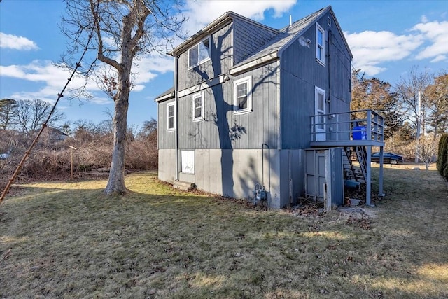 view of side of home with a yard