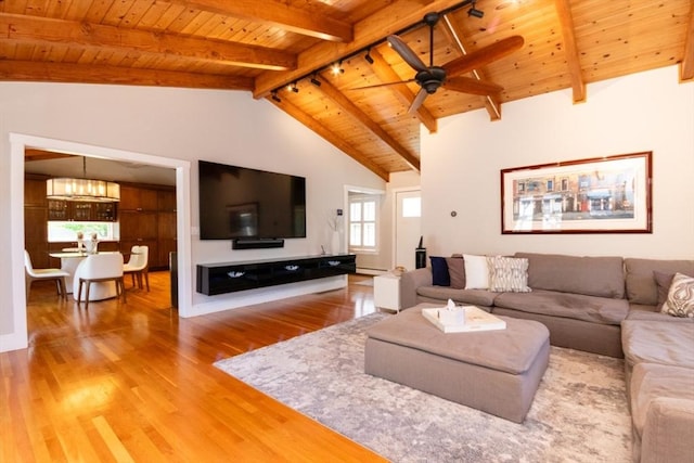 115 Lincoln Rd, Walpole, MA 02081 - living area with vaulted ceiling with beams, ceiling fan with notable chandelier, wood finished floors, and wooden ceiling