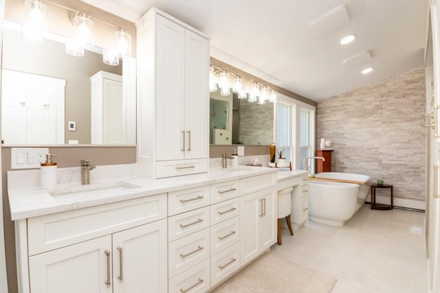 115 Lincoln Rd, Walpole, MA 02081 - bathroom featuring double vanity, a freestanding bath, a sink, tile patterned floors, and lofted ceiling