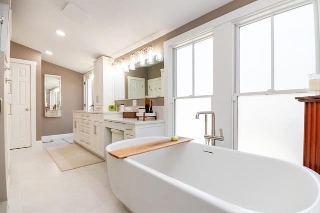 115 Lincoln Rd, Walpole, MA 02081 - full bathroom featuring a freestanding tub, vanity, baseboards, lofted ceiling, and recessed lighting